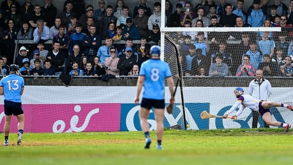 Wexford goalkeeper Mark Fanning dives for that penalty taken by Seán Currie (L) which was eventually awarded as Dublin's third goal at Parnell Park
