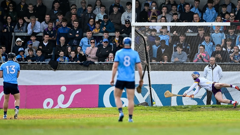Wexford goalkeeper Mark Fanning dives for that penalty taken by Seán Currie (L) which was eventually awarded as Dublin's third goal at Parnell Park