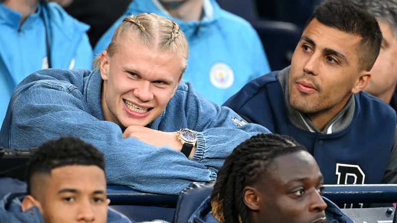 Erling Haaland and Rodri watch last week's 2-1 win over Aston Villa