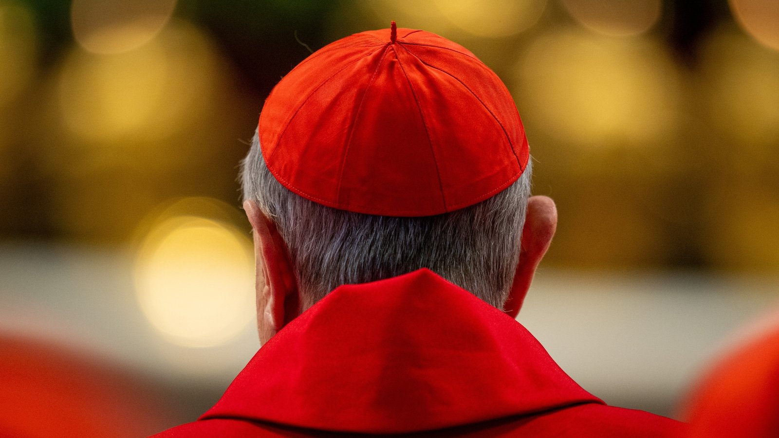 Each cardinal takes turns to walk to the altar, carrying his vote in the air