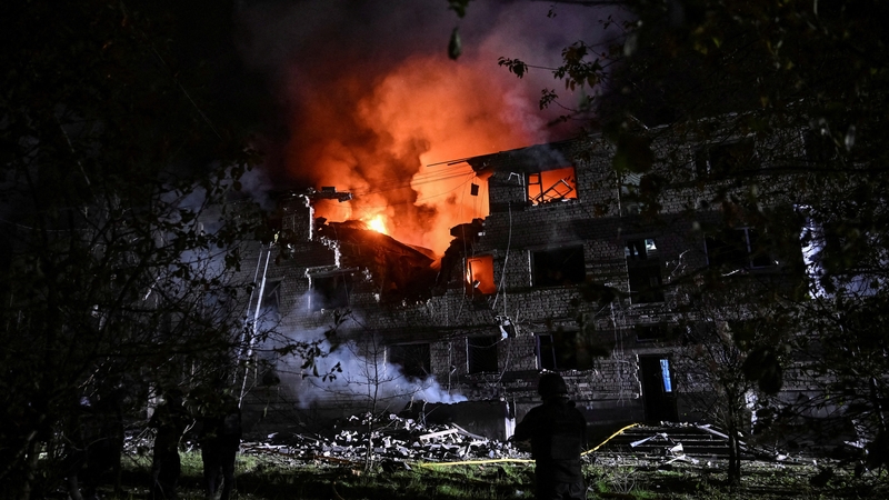 Rescuers work at the site of an apartment building hit by a Russian drone strike in Zaporizhzhia