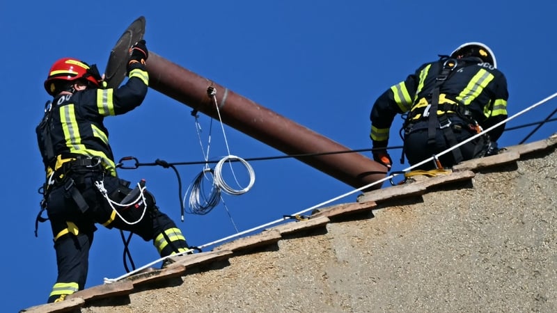 Firefighters installing the chimney on the roof of the Sistine Chapel this morning