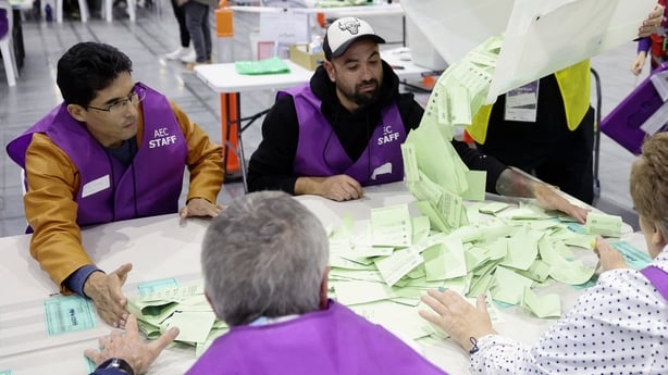 Officials count ballots at a polling station in Melbourne