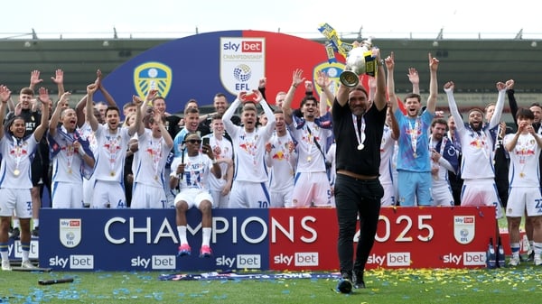 Leeds United manager Daniel Farke celebrates with the trophy after his team were crowned champions