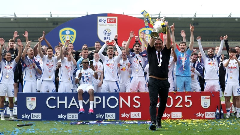 Leeds United manager Daniel Farke celebrates with the trophy after his team were crowned champions