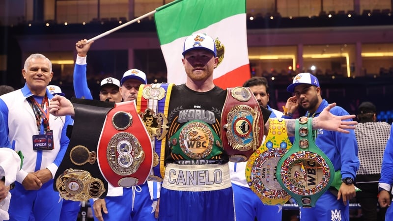 Saul 'Canelo' Alvarez poses with his belts after beating William Scull