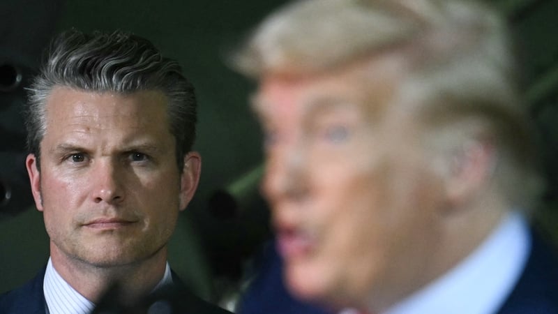 Pete Hegseth, looks on as Donald Trump delivers remarks to the Michigan National Guard last month