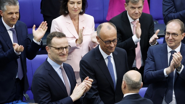 New German Chancellor Friedrich Merz is congratulated by outgoing chancellor Olaf Scholz