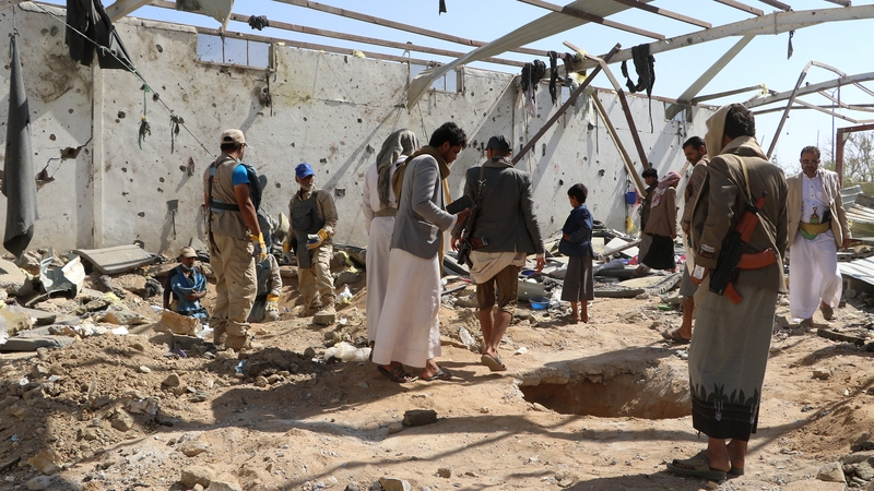 People in Yemen check the rubble of a building hit in US strikes (File image)