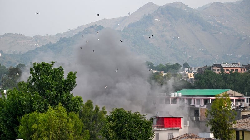 Smoke billows after an artillery shell landed in the main town of Poonch district in India's Jammu region