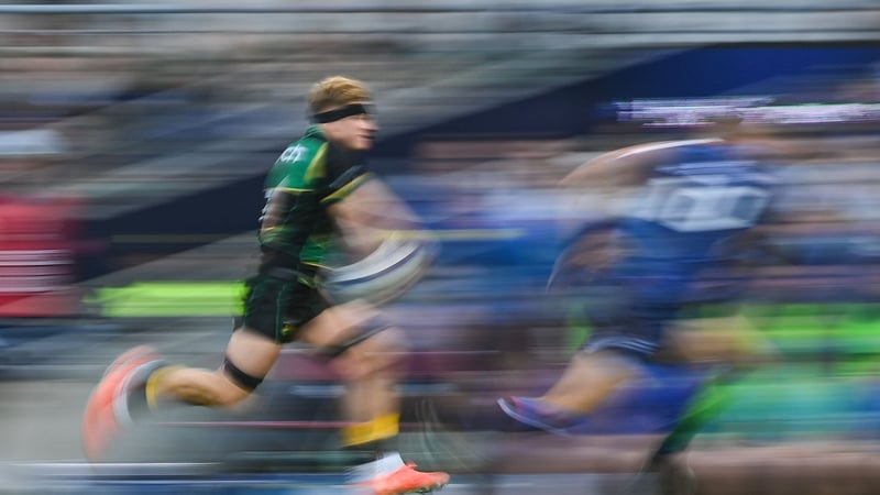 Henry Pollock runs past Sam Prendergast to score Saints' third try