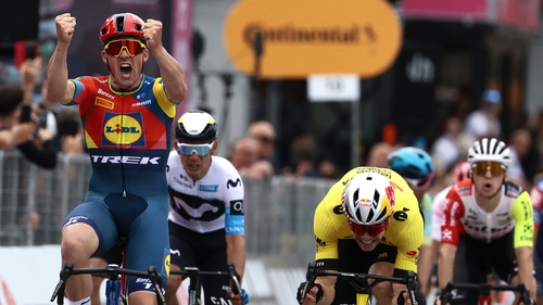 Mads Pedersen, next to Wout Van Aert (R), celebrates as he crosses the finish line