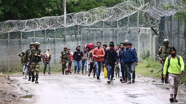 Workers in Uri, India, evacuate after artillery shelling by Pakistan
