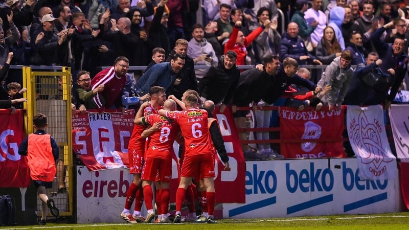 Shelbourne players mob Kerr McInroy after his late winner