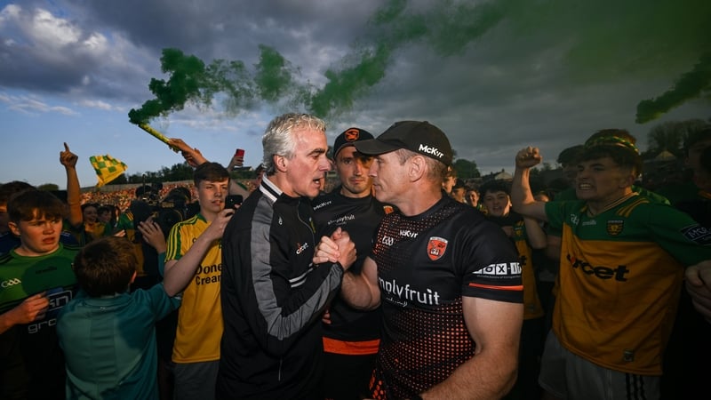 Donegal manager Jim McGuinness shakes hands with Armagh counterpart Kieran McGeeney following the game
