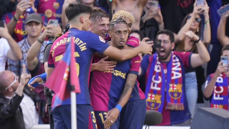 Barcelona brace boy Raphinha is embraced by his team-mates