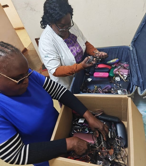 Villagers in Malawi sort through the donated glasses 