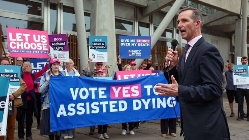 Liam McArthur MSP meets with supporters of a law change on assisted dying as they demonstrate outside the Scottish Parliament