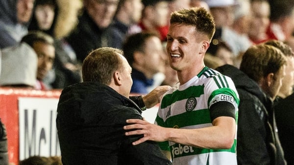 Johnny Kenny (R) is congratulated by Brendan Rodgers during the victory over Aberdeen
