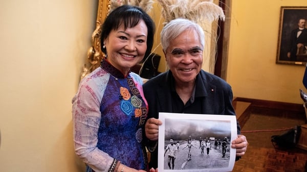 Kim Phuc Phan Thi (L), known as the 'Napalm Girl,' poses with photojournalist Nick Ut