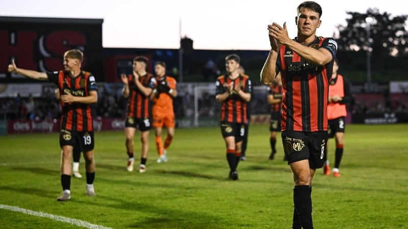 Goalscorer Dayle Rooney leads the celebrations after his side's victory at Dalymount Park