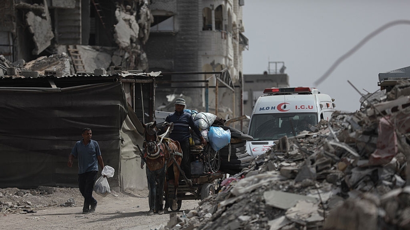 Palestinian residents begin fleeing towards areas they believe to be safer, carrying their belongings, following heavy Israeli attacks