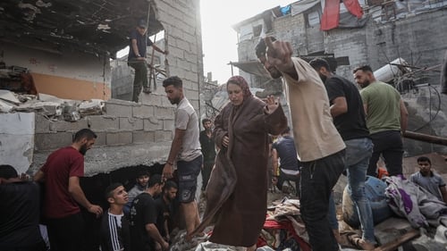 Search and rescue teams work under rubble after the Israeli army attacked a building at the Jabalia Refugee Camp