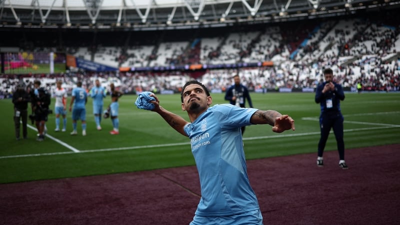 Morgan Gibbs-White throws a shirt to the fans after Forest's win at West Ham