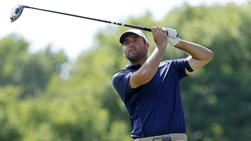 Scottie Scheffler watches his tee shot on the eighth