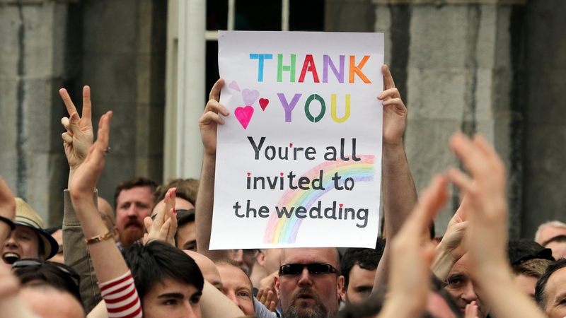 A supporter holds a sign reading 'Thank You - You're All Invited to the Wedding' as he celebrates outside Dublin Castle following the result of the same-sex marriage referendum in Dublin on May 23, 2015. Photo: Getty Images
