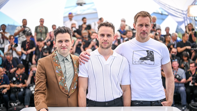 Harry Melling, Harry Lighton and Alexander Skarsgård pose on the red carpet in Cannes