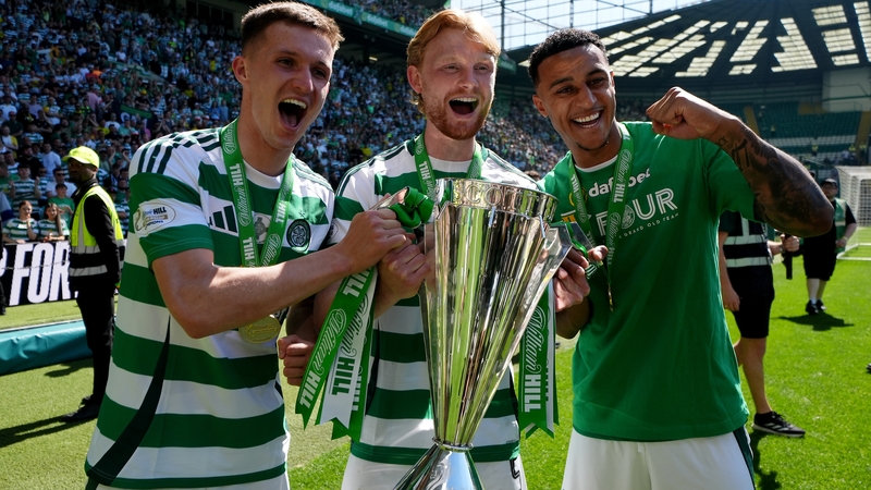 Celtic's Johnny Kenny (L), Liam Scales (C) and Adam Idah (right) with the Scottish Premiership trophy