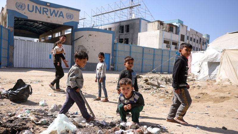 Children play in front of the closed UNRWA headquarters in Gaza city