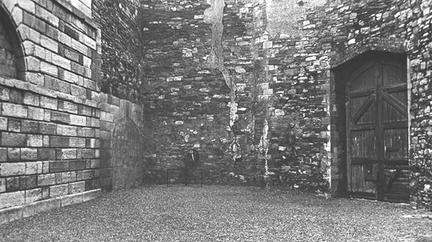 a stone wall with a door open