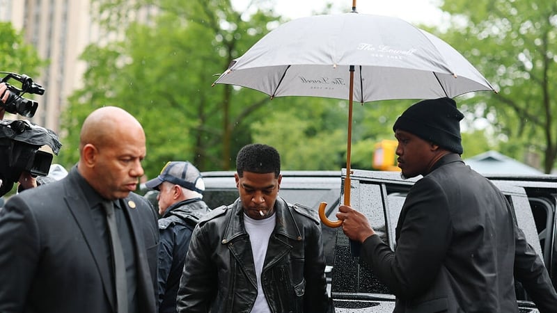 Rapper Scott "Kid Cudi" Mescudi, centre, arrives at court ahead of his testimony