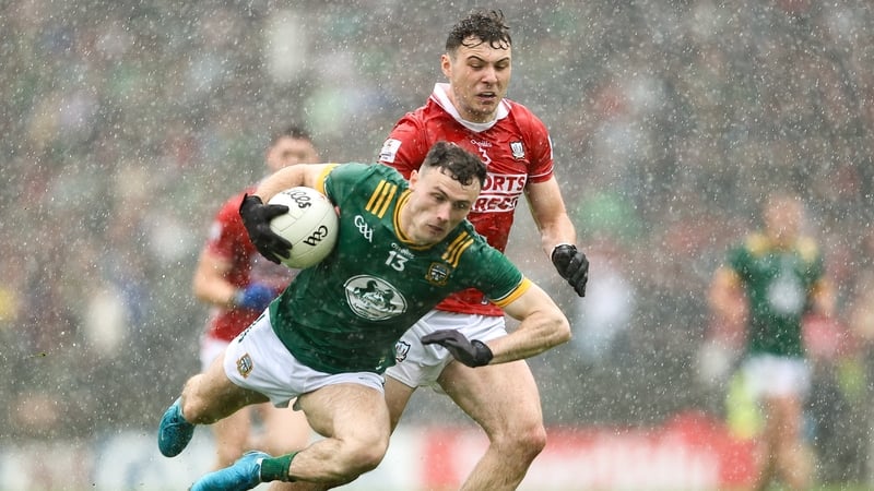 Meath's Jordan Morris is tackled by Cork's Daniel O'Mahony in the rain in Navan