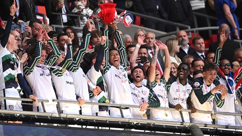 Jobe Bellingham hoists the play-off trophy as Sunderland return to the top flight