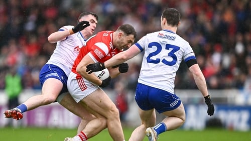 Sam Mulroy of Louth is tackled by Mícheál McCarville, left, and Killian Lavelle