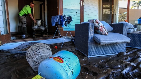 Residents clean a flood-damaged house at Glenthorne in Taree, Australia