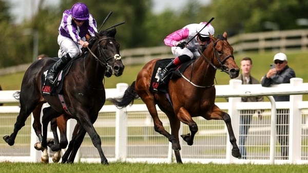 Albert Einstein, with Ryan Moore up, left, races alongside Power Blue, with David Egan up, who finished second, on their way to winning the GAIN Marble Hill Stakes during day three of the Tattersalls Irish Guineas Festival at The Curragh Racecourse in New