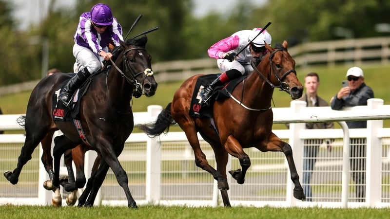 Albert Einstein, with Ryan Moore up, left, races alongside Power Blue, with David Egan up, who finished second, on their way to winning the GAIN Marble Hill Stakes during day three of the Tattersalls Irish Guineas Festival at The Curragh Racecourse in New