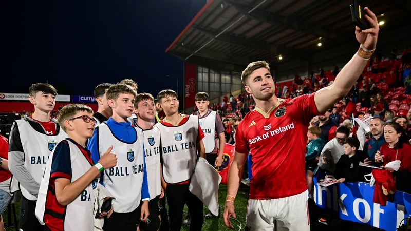 Jack Crowley poses for a picture with the ballboys following Munster's win over Benetton