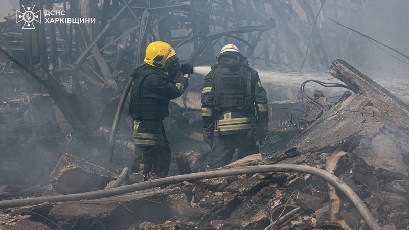 Firefighters try to extinguish a blaze at a building in the Kharkiv region