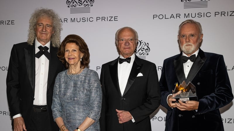 (L-R) Queen's Brian May, Queen Silvia of Sweden, King Carl XVI Gustaf of Sweden, and Queen's Roger Taylor at the awards ceremony in Stockholm on Tuesday