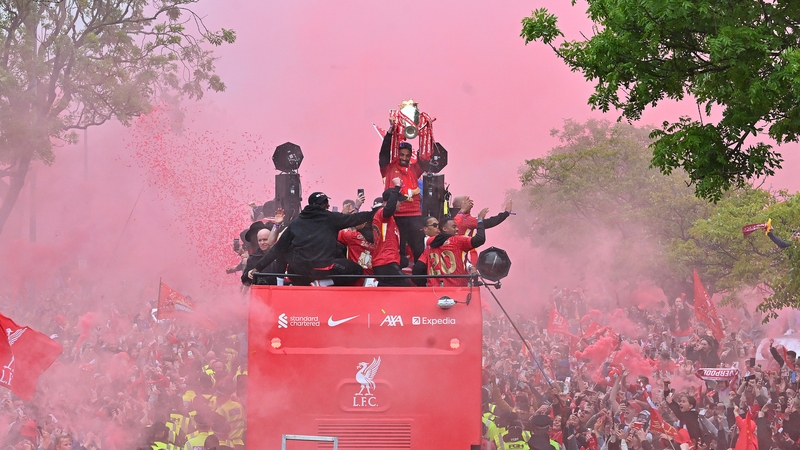 Mo Salah raises the Premier League trophy during Liverpool's parade through the city