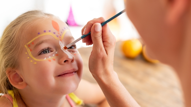 a child getting her face painted