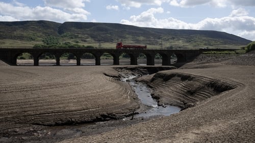 The bed of Woodhead Reservoir is partially revealed by a falling water levels near Glossop, in England