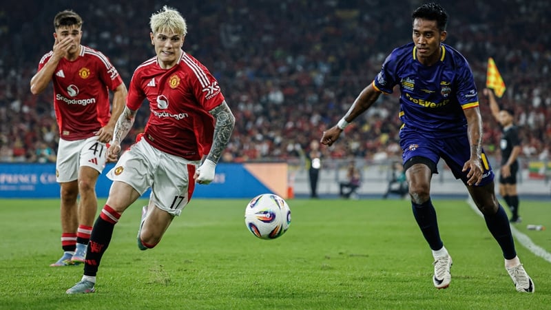 Harry Amass (L) and Alejandro Garnacho (C) of Manchester United in action against the ASEAN All Stars in Kuala Lumpur