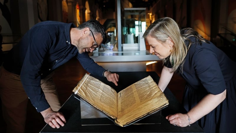 Matthew Seaver, exhibition curator at the National Museum of Ireland, and Maeve Sikora, keeper of Irish antiquities at the museum, assess one of the manuscripts