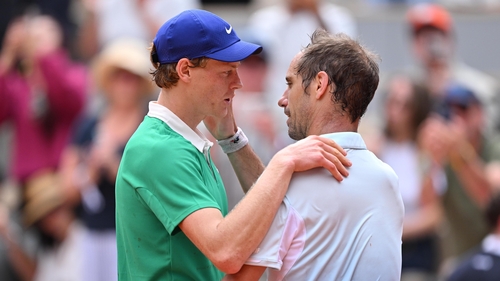 Jannik Sinner and Richard Gasquet embrace after their second round match